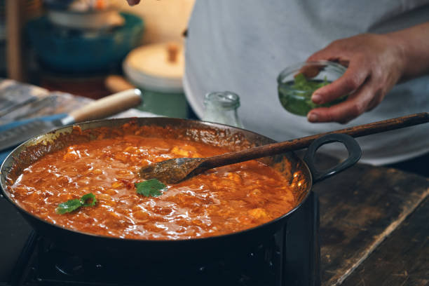 istock Preparing Indian Chicken Curry in Domestic Kitchen 1328906547