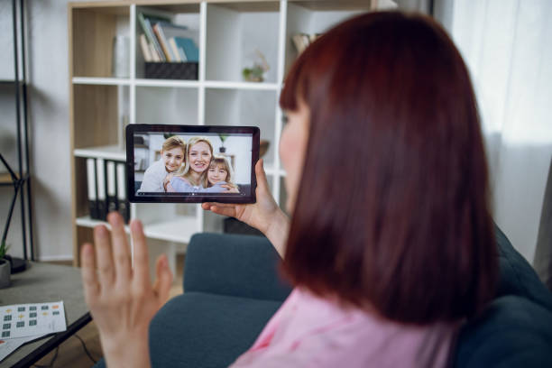 istock Woman talking with relatives during video call on tablet 1328906666
