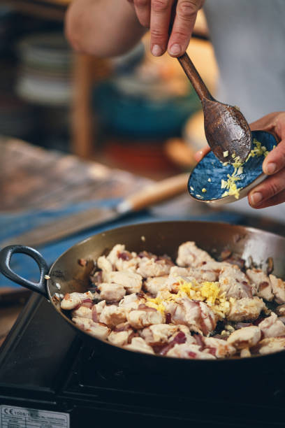 istock Preparing Indian Chicken Curry in Domestic Kitchen 1328909056