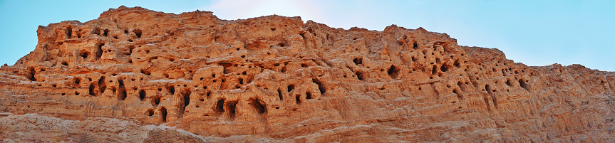 A mountain of quarry and river sand, in which the birds made nests. Mountain, canyon, nesting place of birds.