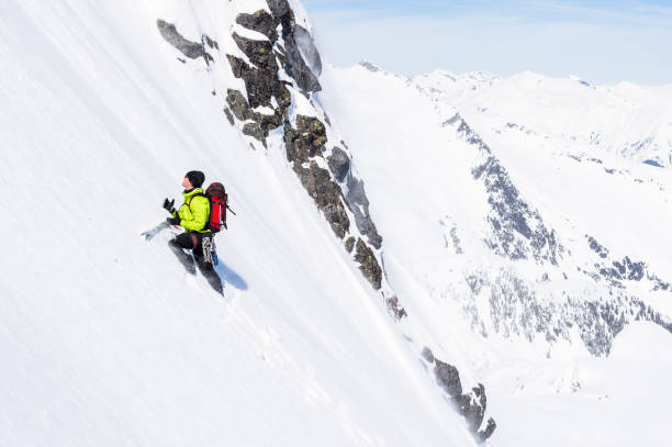 istock Backcountry skier climbs snowy mountain slope 1328911279