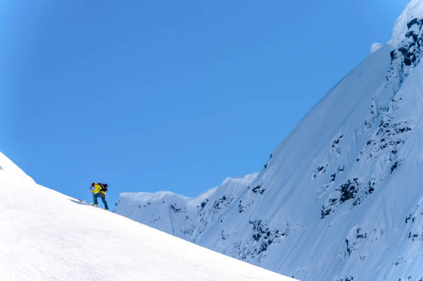 istock Backcountry skier climbs snowy mountain slope 1328911319