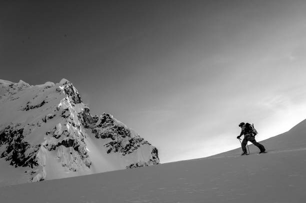 istock Backcountry skier climbs snowy mountain slope 1328911334