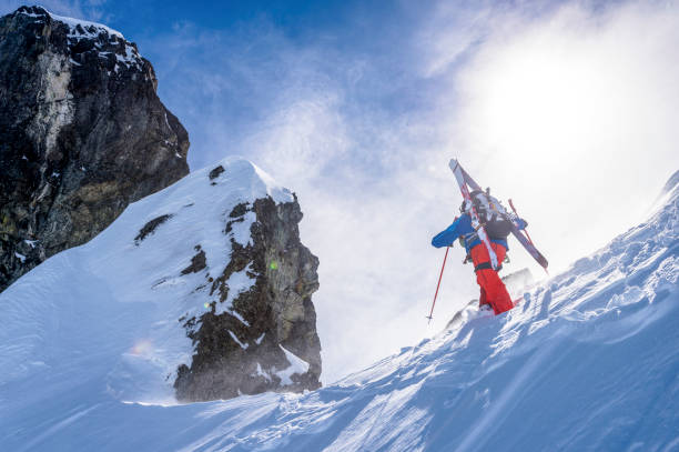 istock Backcountry skier climbs snowy mountain slope 1328911412