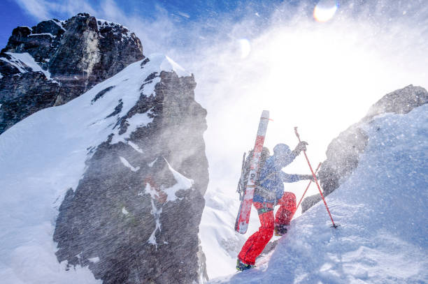 istock Backcountry skier climbs snowy mountain slope 1328911431