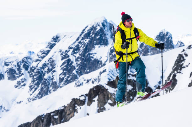 istock Backcountry skier climbs snowy mountain slope 1328911576
