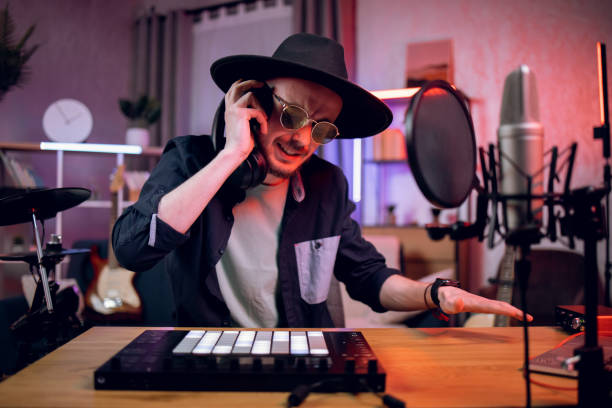 istock Inspired man in headphones making new track at studio 1328917221