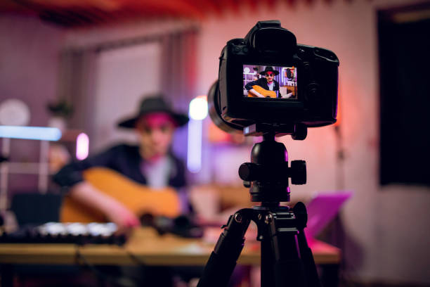 istock Man recording online lessons while playing guitar 1328917582