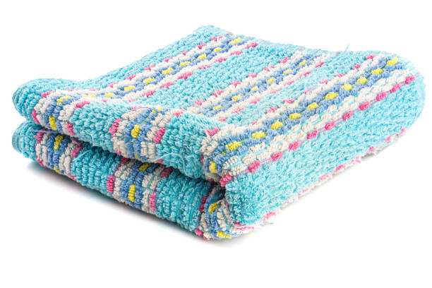 istock folded old cleaned turquoise towel with stripes ornament isolated on white background 1328919990