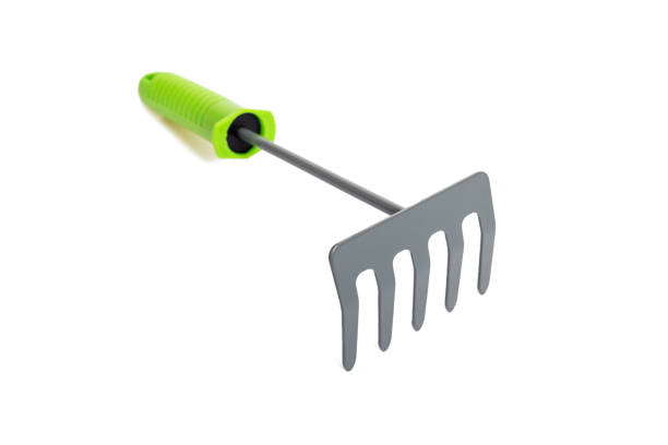 istock Small garden rake with green plastic handle isolated on a white background. 1328928118