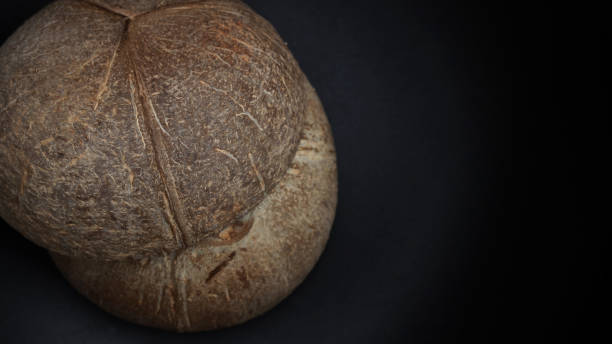 istock two halves of coconut shell on black background 1328929314