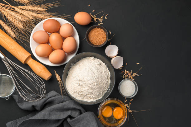 istock Baking ingredients on a black background. Flour, eggs, sugar 1328929855