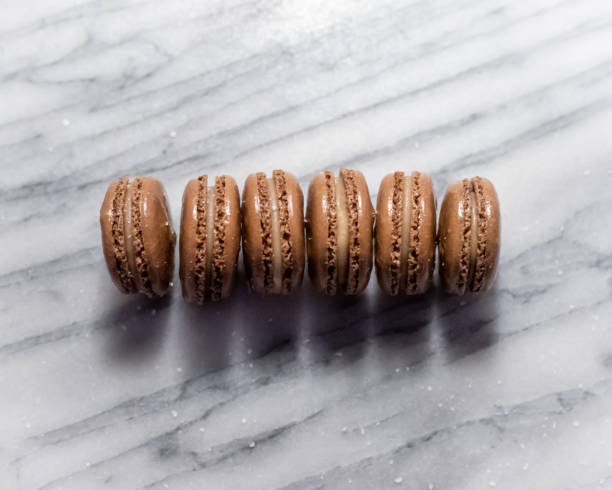 istock Chocolate Salted Caramel Macarons on White Marble 1328929996