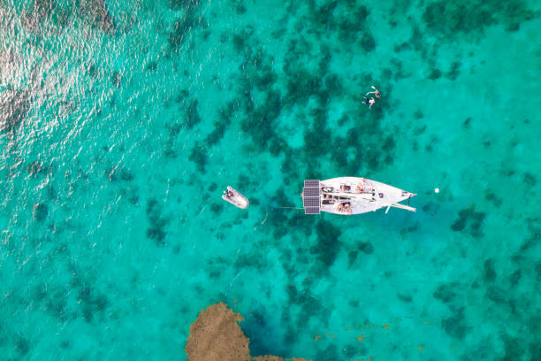 Aerial over sailboat along coastline