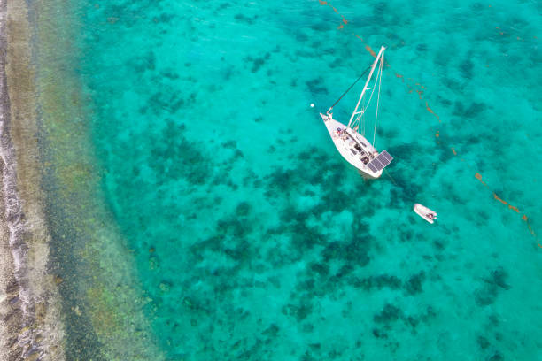 istock Aerial over sailboat along coastline 1328931692