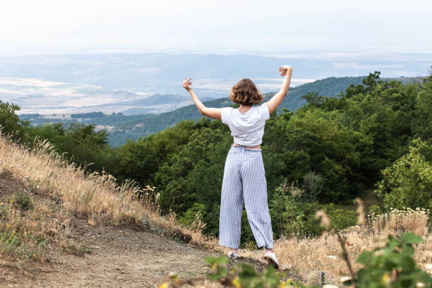 istock Dancing girl in the mountains in daylight 1328933390
