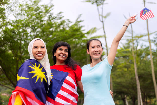 Friends with Malaysian flag, celebrating Hari Merdeka