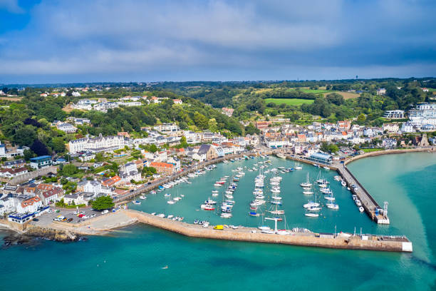 St Aubin's Harbour, Jersey CI Airial drone image of St Aubn's Harbour and Village at high tide in the sunshine. Jersey Channel Islands jersey england stock pictures, royalty-free photos & images