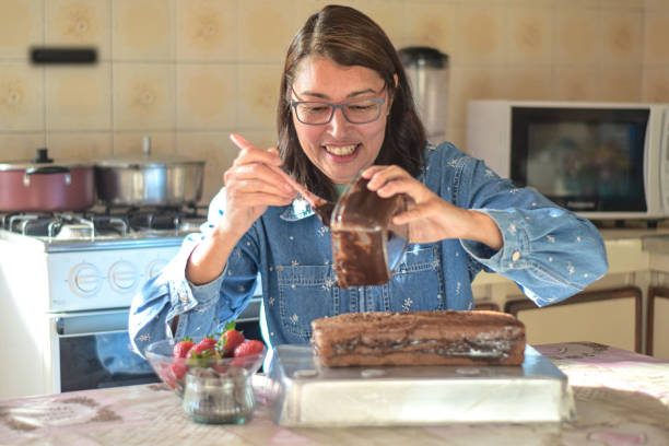 istock Mature woman preparing a chocolate cake at home 1328957542