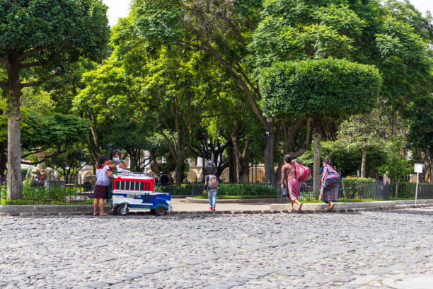 antigua guatemala, sacatepequez, guatemala; 07-02-2021: hispanic woman selling ice cream in the central park during a sunny day - editorial guatemala antigua tourist imagens e fotografias de stock