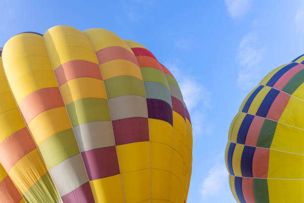 istock Colorful hot air balloons over blue sky 1328962532