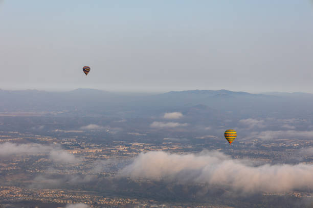 istock Colorful hot air balloons on blue sky with clouds 1328962569