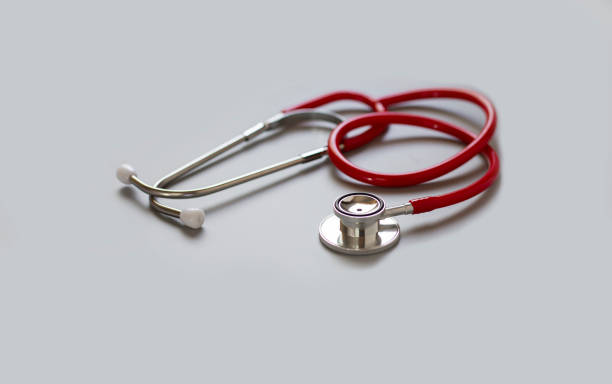 istock red stethoscope on gray background ,health care concept. 1328964384
