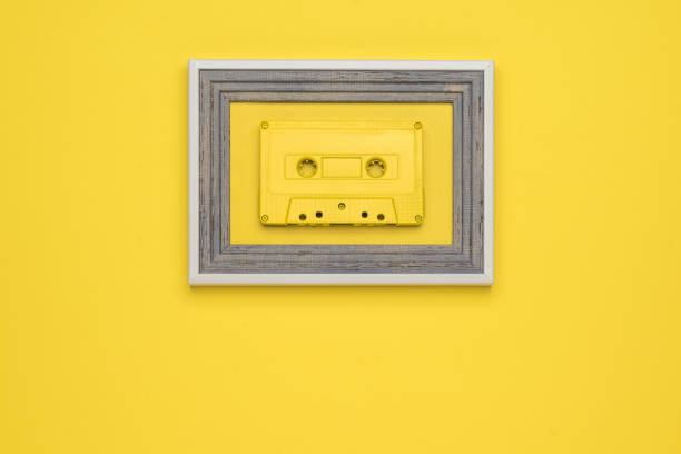 istock A yellow tape cassette in a frame on a yellow background. Flat lay. 1328967477