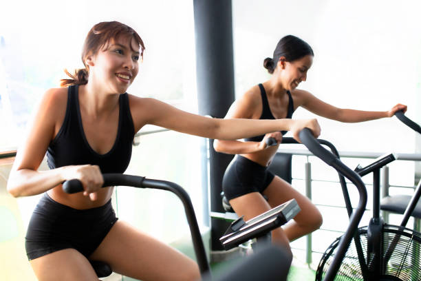 istock girls exercising bike 1328967695