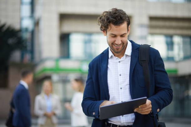 istock Young businessman using digital tablet outdoors 1328971313