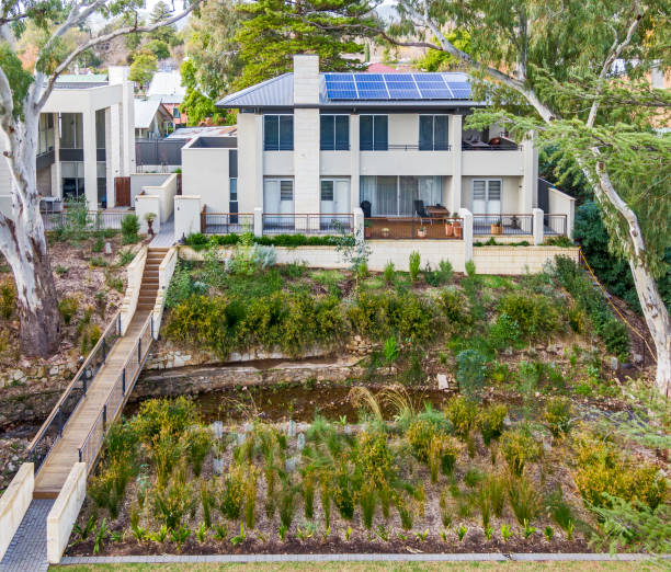 istock Front view of modern new two-level house amongst trees 1328975370