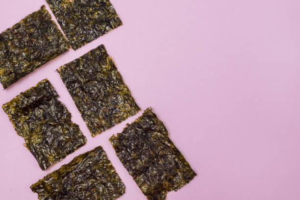 istock Crispy Dried Seaweed Japanese Snack Pink Background Copy Space 1328976094