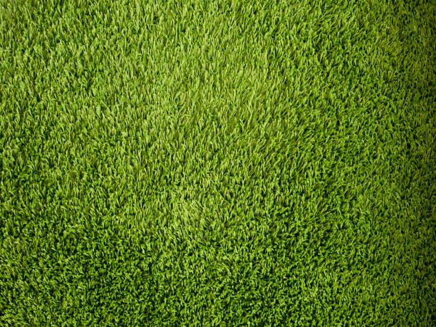 istock Green background made of artificial threads. Green fabric texture and pattern for background. 1328977073