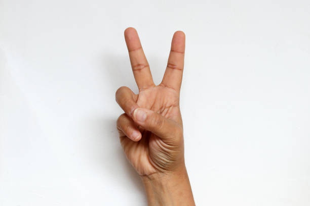 istock hand with 2 fingers pointing stand for peace sign 1328978035