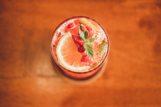 istock Raspberry with lemonade in glass on wooden background. Top view 1328980483