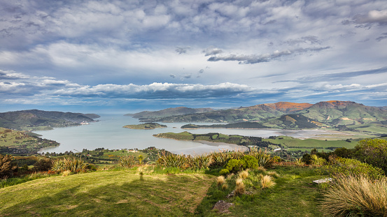Christchurch Bay View Panorama. Head of the Bay View under blue summer sky. View from Summit Road at Christchurch Adventure Park - Ohinetahi Bush Reserve over Head of the Bay with Otamahua - Quail Island. Head of the Bay, Christchurch, Canterbury Region, South Island, New Zealand, Oceania