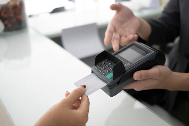 istock Customer standing near bar counter and making payment with credit card. 1328982108
