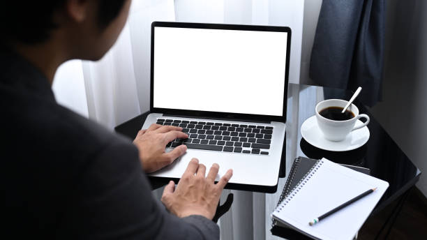 istock View over businessman shoulder working with laptop in office. 1328982110