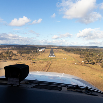 This image is of a Cessna 172S on final for Warwick runway 09. The photograph was taken on a private Cessna 172 on a navigation route. The Cessna 172 Skyhawk is an American four-seat, single-engine, high wing, fixed-wing aircraft made by the Cessna Aircraft Company. First flown in 1955, more 172s have been built than any other aircraft. It was developed from the 1948 Cessna 170, using tricycle undercarriage, rather than a tail-dragger. Warwick is a town and locality in southeast Queensland, Australia, lying 130 kilometres south-west of Brisbane. It is the administrative centre of the Southern Downs Region local government area.