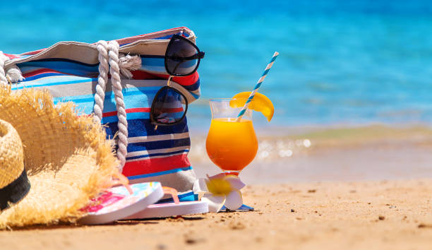 istock Bag and things for relaxing on the sea beach. Selective focus. 1328987207