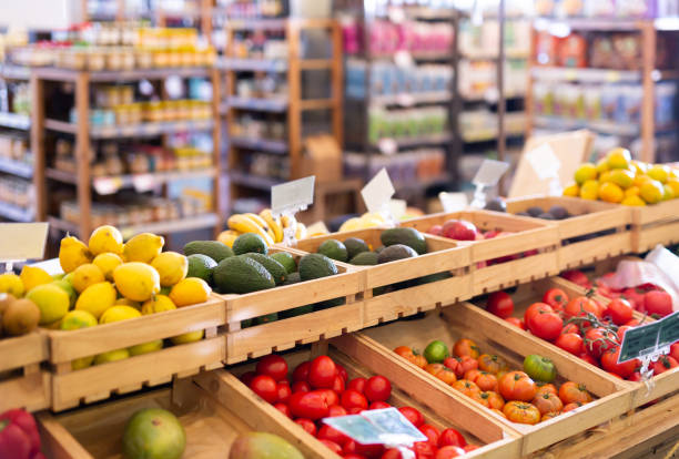 Fresh vegetables and fruits on counter in grocery supermarket Fresh vegetables and fruits on counter in a grocery supermarket supermarket stock pictures, royalty-free photos & images