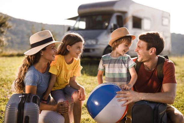 istock Happy family talking before their vacation at trailer park. 1328991743