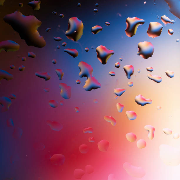 istock Abstract water droplets on the glass with a colored blurred background 1328993573