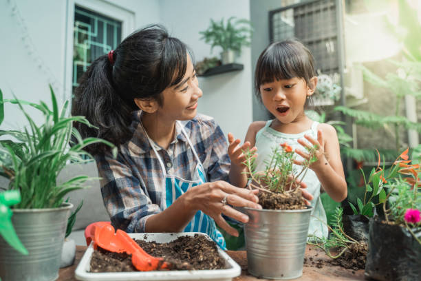istock cheerful mother and daugther while planting 1328994560
