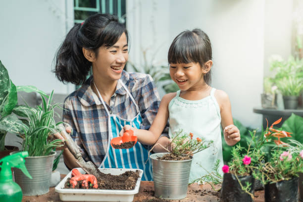 istock cheerful mother and daugther while planting 1328994565