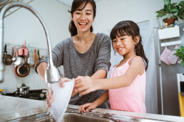 istock kid enjoy washing the dishes together 1328996303