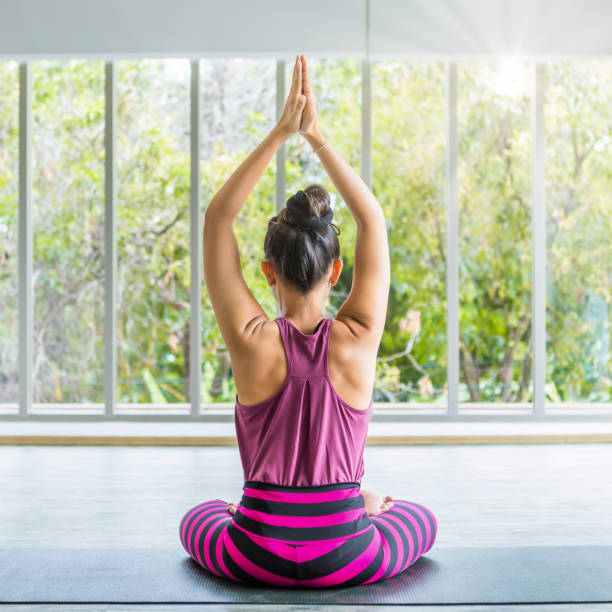 istock Asian women workout practicing yoga training put on pink clothes and practice meditation wellness lifestyle and health fitness concept in a gym,copy space 1328996341