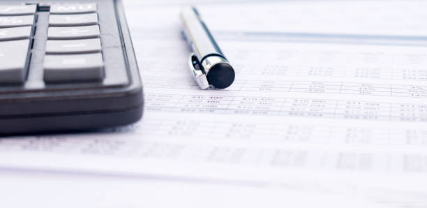 istock Calculator, pen and financial statement, financial background 1328997582