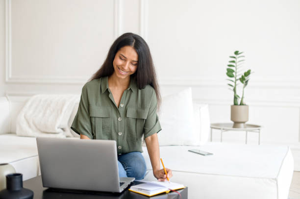 istock Indian girl student learning online, watching webinar at laptop computer 1328998868