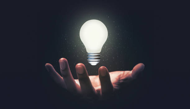 istock Hand hold glowing idea light bulb and innovation thinking creative concept on success inspiration dark background with solution creative business design. 1328999072